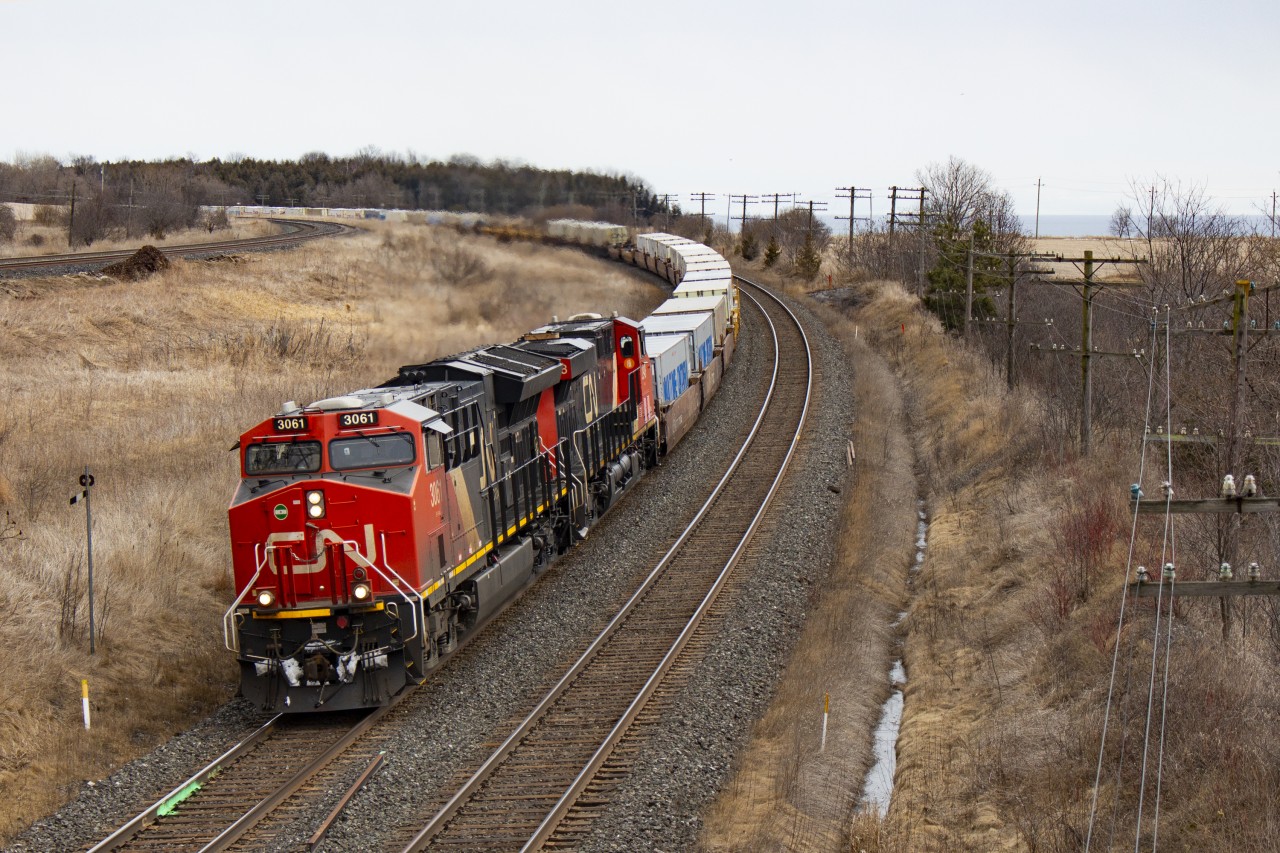 Two Canadian National GEs rumble through Lovekin with a stack train. To the left is the CP mainline, and to the right Lake Ontario. It doesn't get much better...maybe a couple dozen degrees warmer!