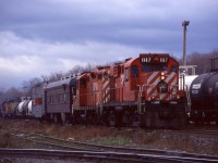 This photo seemed fitting for this dreary weather. It’s hard to believe I shot this over 20 years ago, but this day after work I made it up to Guelph Jct. and managed to catch the rail geometry train stopping on the main so the crew could take a break in the office. Back then the 1117 was still with its original mother, GP9 8243 but within a few years it would find a new mate GP38 3057, which it would be mated to until its last days before being scrapped in 2003. Behind the train a westbound with a former Union Pacific SD40 trailing can be seen just about to head out onto the OCS.