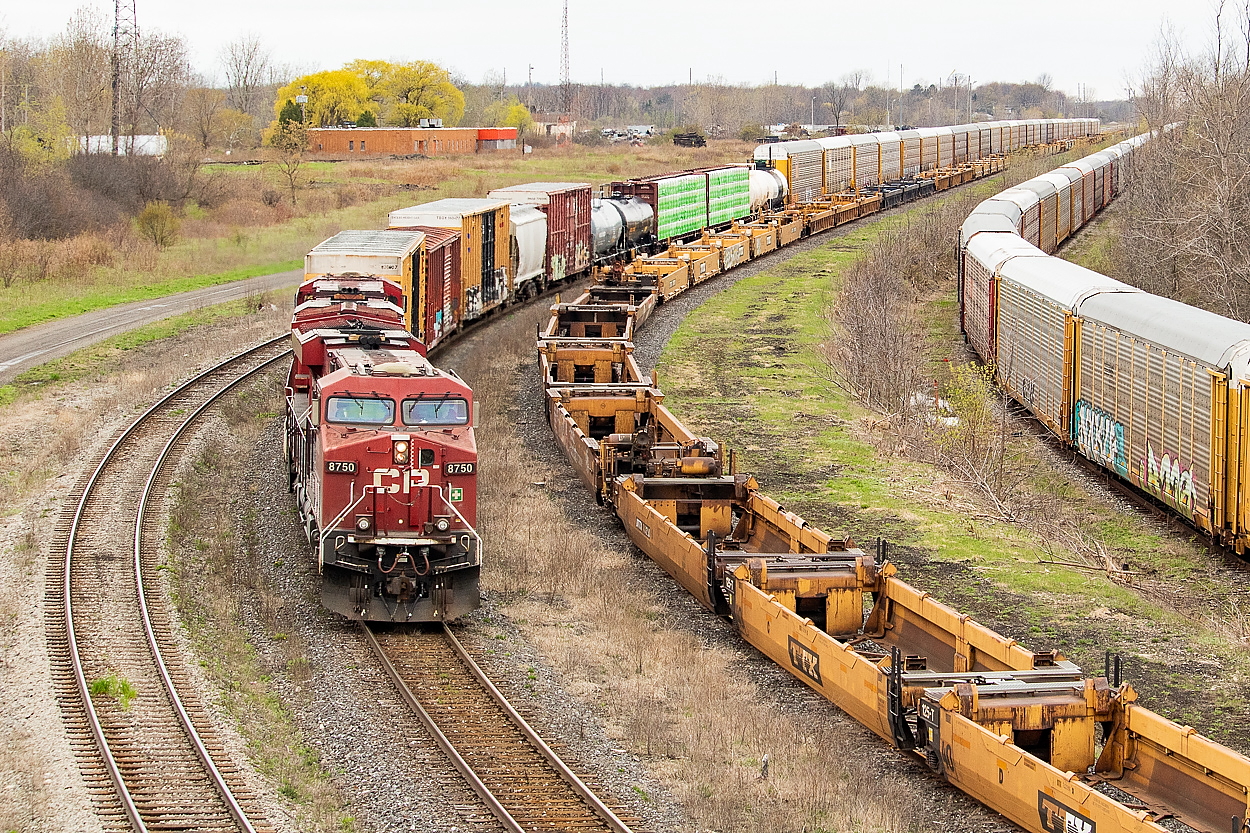 CP 246 is pictured here on the final stretch to the International Bridge, where it will cross into Buffalo, New York. The well cars in the middle are in storage I believe. The racks to the right are on CN 538, which minutes before had just crossed the International Bridge in the opposite direction, returning from Frontier Yard with 134 cars in tow. They would set a long string of racks off on that track before heading back to Port Rob with a much smaller train.
