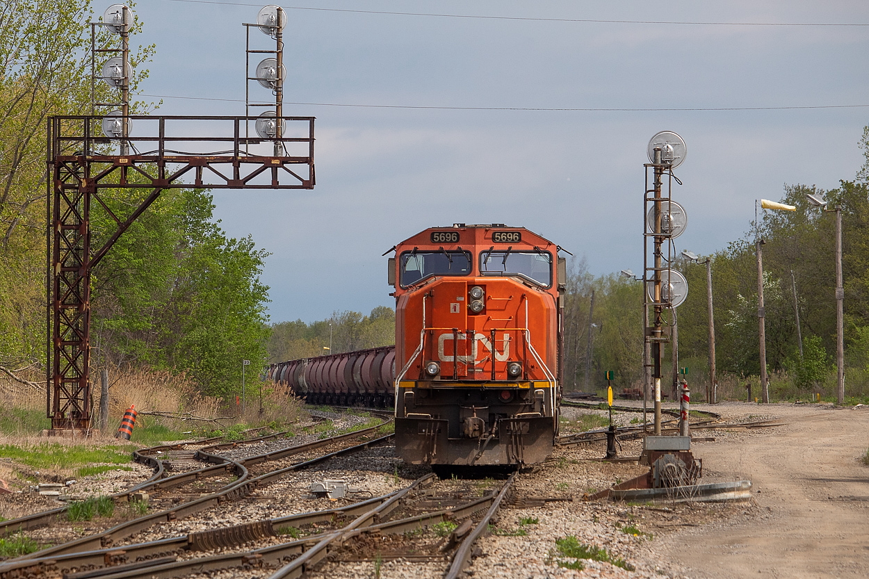 It was a cloudy day for the most part on the holiday Monday, but a few sucker holes opened up allowing for some sun in the shots. I happened to get some sun for 421 shortly after it pulled into Port Rob, but I am not posting this shot for what's in the sun. I am posting it for what's trailing in the shadows, taking one of their final rides. In the background you can see some of the string of the 43 old 3800 cubic foot CN cylindrical hoppers that came in on 421, destined for scrap. They are being interchanged with Trillium and will be taken to SLM to be cut up. When all is said and done, nearly 400 of them will be scrapped down here. There are quite a few scattered throughout Trillium's yards already. Could make for some interesting shots on 562 as they are being interchanged, or on Trillium as they are being moved. Hopefully someone more local can catch the movements.