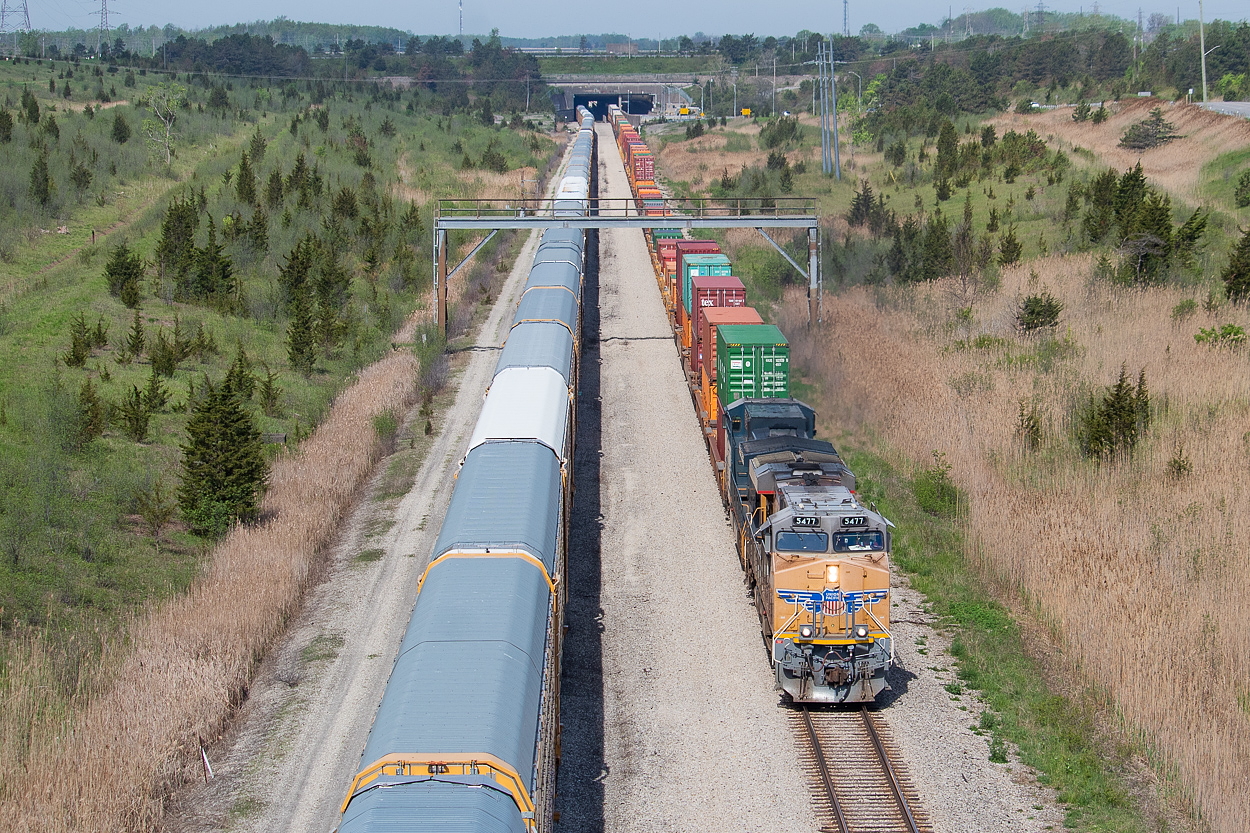 It's not very often these days you get a mainline freight cooperating with the sun to allow for this shot. 143 is typically through under the cover of darkness, and 246 and 254 are backlit by the time they get here. A rather late and a rather interesting 143 provided the impetus for this shot to happen, and I had no issue making the trek to Welland to get out ahead of 143 in sufficient time for this. Pictured here, 143 has just emerged from under the Welland Canal, and is ducking under one of the redundant signal bridges scattered throughout the area (see another example at Feeder here. I know of several others who caught this train, including Matthew Tozier at Fort Erie, and I look forward to seeing their shots over time. Arnold Mooney posted a shot a few years ago from back in 1990 looking the other way from the canal, of a Norfolk Southern stack train headed for Dain City. In my shot you can see some of the changes he noted such as the removal of the middle track and the redundancy of the signal bridge. As Arnold notes, the NS train in his shot is running on the Cayuga Sub, which the racks in my shot are sitting on. This is now CP's Brookfield Siding. Additional context and/or corrections on this are of course welcome.