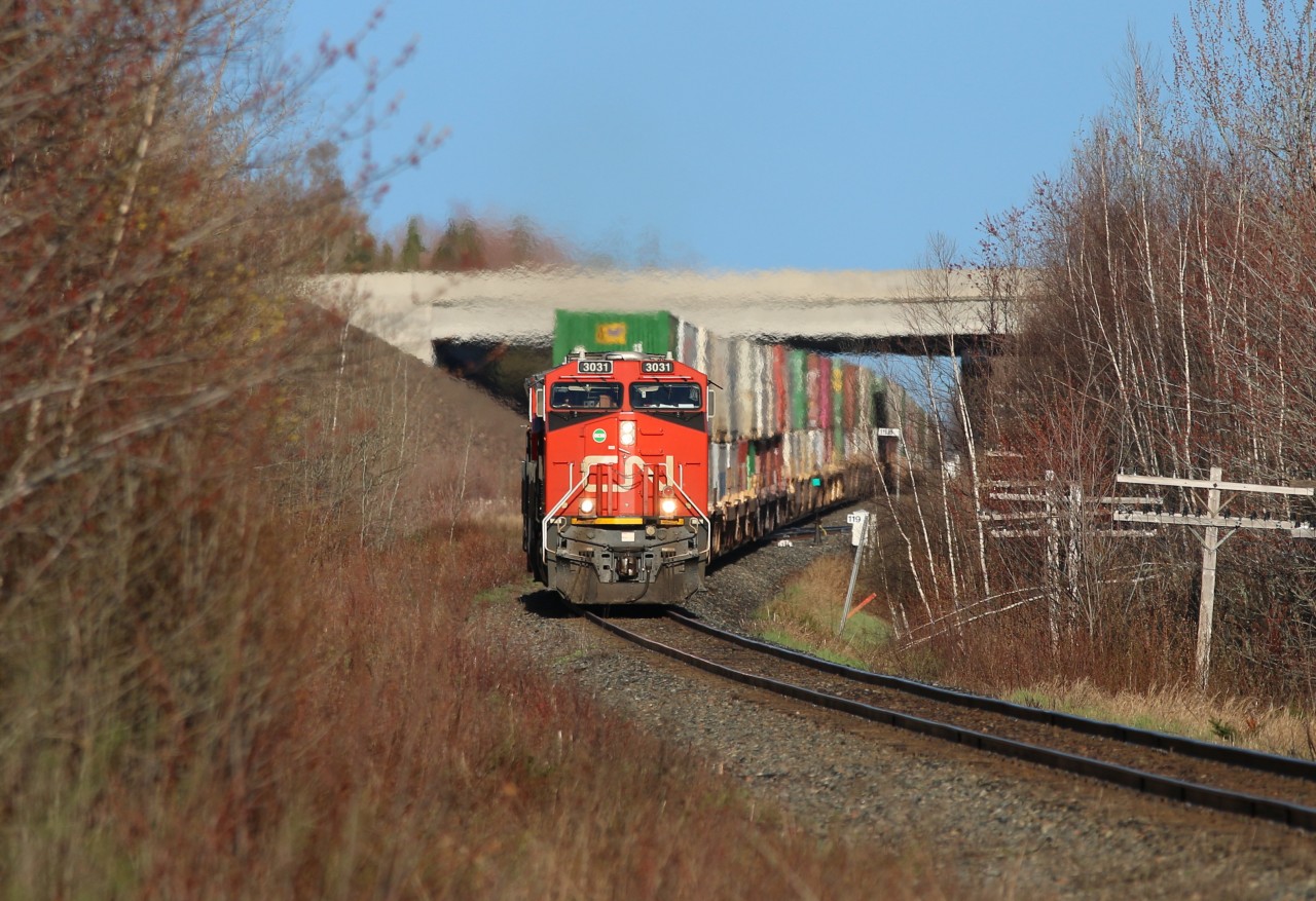With the TCH in the background, CN train Q120 highballs for the east coast ocean leaving Moncton behind on this bright sunny morning.