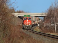 With the TCH in the background, CN train Q120 highballs for the east coast ocean leaving Moncton behind on this bright sunny morning.