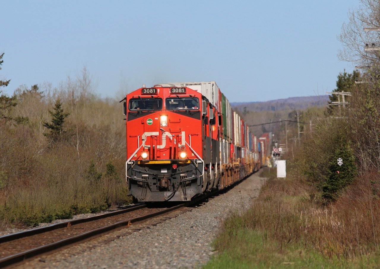 Q120 rushing along the straight stretch near Debert NS stopping traffic at several crossings along its path.