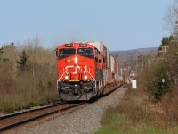 Q120 rushing along the straight stretch near Debert NS stopping traffic at several crossings along its path.