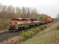 CN 148 passes Mile 30 on the Halton sub with a pair of BCOL  Dash 8-40CMu units up front in BCOL 4604 and BCOL 4606. The weather cooperated some what as it stopped raining just before the trains arrival.