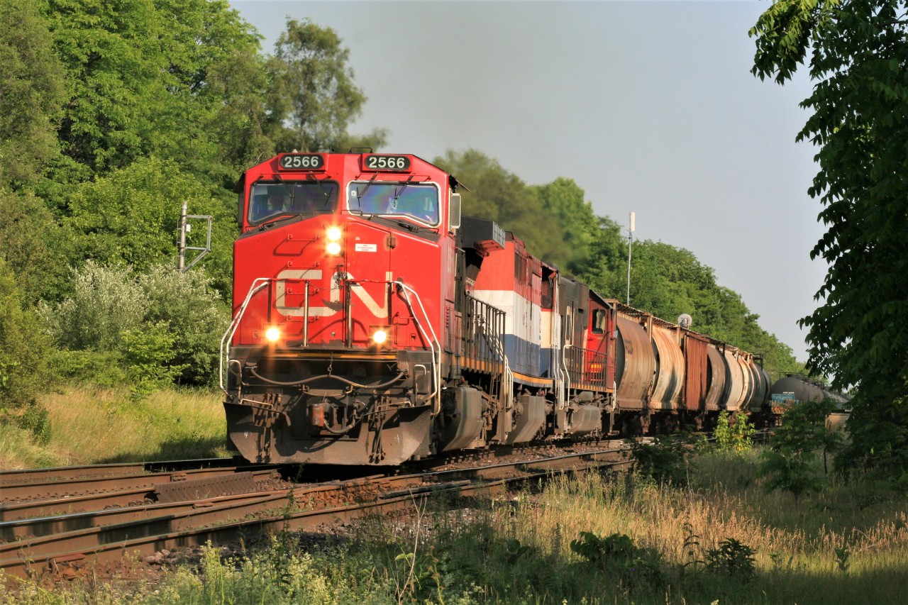 CN train 435 utilizes the mainline crossovers on the Dundas Subdivision at Hardy in the city of Brantford on a steamy summer afternoon. The consist included; 2566, BCOL 4614 and 5448 with work ahead in Paris.