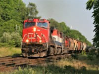 CN train 435 utilizes the mainline crossovers on the Dundas Subdivision at Hardy in the city of Brantford on a steamy summer afternoon. The consist included; 2566, BCOL 4614 and 5448 with work ahead in Paris. 