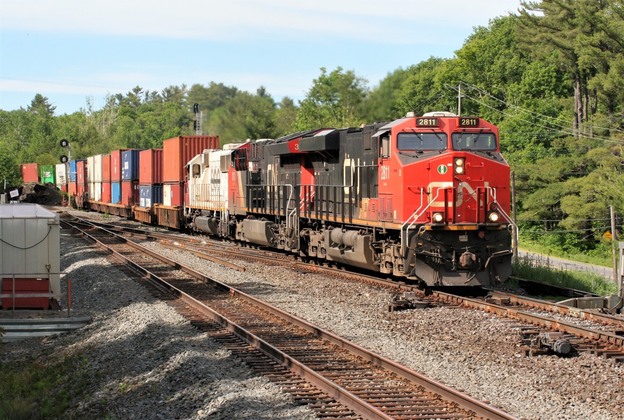 CN train 112 heads southbound through Boyne, just outside of Parry Sound, Ontario on the Bala Subdivision. Powering the train are CN 2811, CN 3118 and CEFX 6002, which is former SOO Line SD60 6002.