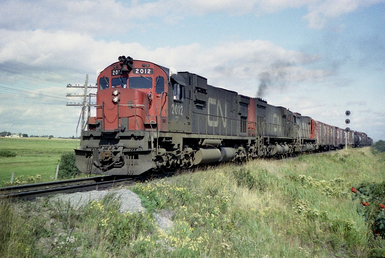 Westbound approaching Sackville. New Brunswick is this nice MLW trio; CN 2012, 2337 and 2320. I sure miss these old monsters.