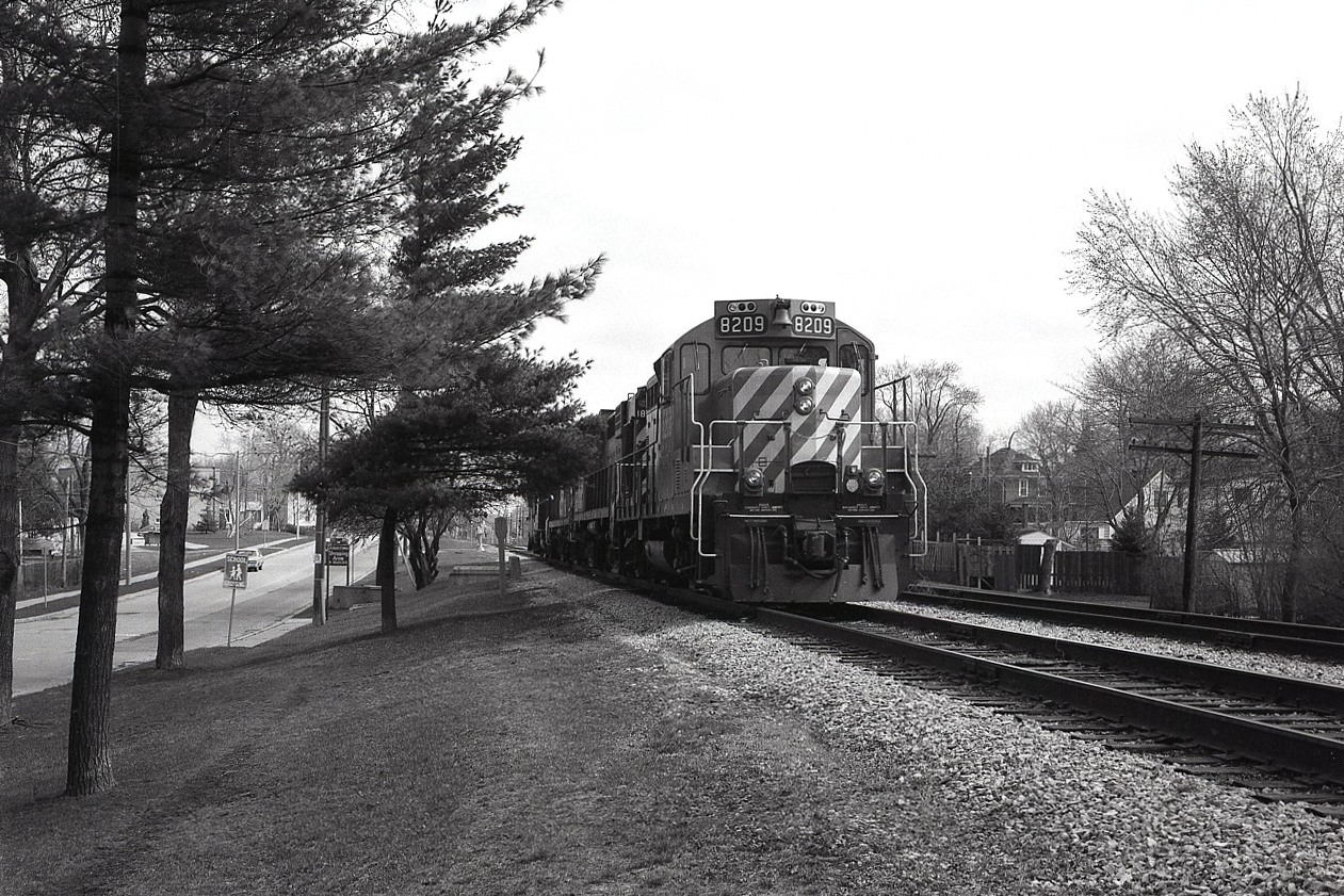 Not something I recall seeing before here; a 4 unit light power move. It is possible they ran some traffic over to the CN yard and are returning to Montrose Yard (mile 4). Anyway, the units are CP 8209, 1806, 1812 and 8212. Sounds like power off of a 500-series train, one of the Toronto to Buffalo (and return) dailies.
That is Palmer Av to the left and the scene is near Mile 1. This is now a walking trail.
Photo was taken using medium format 2x3 roll film back on a Speed Graphic. ISO 400 film.