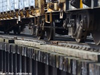 I alluded to CN completely re-decking this bridge not long after takeover in <a href=http://www.railpictures.ca/?attachment_id=37043 target=_blank>This photo</a> and this may demonstrate why it was done. In this photo, Wooden timbers groan and creak as a loaded GEXR southbound crosses the speed river. Look at how many of the members are higher than others - there was quite the amount of deflection as the train crossed and led me to take notice with a telephoto close up. The outside rails all dated to 1902 G.T.R Barrow Steel 80 lb and the inside guard rails as old as 1870's - inside rails all gone now when bridge re-decked - according to local sources the first re-decking since 1959. Rumours that new rail is coming to the spurs in the not too distant future..
