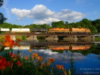 Orange daylilies match the G&W livery as GEXR 582 heads for home crossing the Speed River at Hespeler on a warm, humid summer day. The mother/slug set was assigned to the train for a while during this time period. Really enjoyed the flared radiators of the 3806.