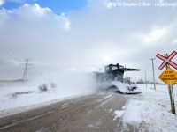Around Goderich, the locals tell tales of a dark monster that appears in the worst of winter, most famously at Wards Cut. They also say it lives off of, and devours snow, only appearing when drifting is over 10 feet high. I bear photographic evidence of the dark monster above: roaring past an unprotected crossing, appearing out of a sea of snow like a whale breaching the surface, hungry to dive into the next drift just behind me where the monster disappears again.