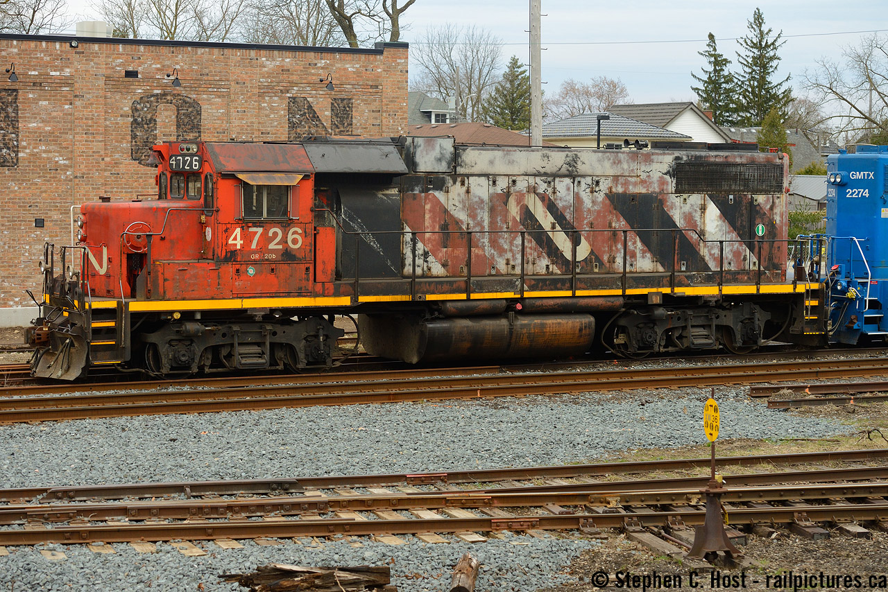 CN may have some really ugly units. We've seen a few posts of them - and feel free to post your findings. But let's be brutally honest - CN has the best roster of any Class 1 in North America right now. Period. Despite implementing (and Pioneering) PSR on a Class 1 we still have a lot of good stuff in both the six axle and four axle worlds. Generations of power. Some of it is also really UGLY. I don't like ugly stuff, I never have.. but I enjoy what is here and shoot things as they lie (Like in Golf).
So what's this then? CN 4726. It's a Zebra. It's Noodle. Zoodle perhaps? Really needs a lick of paint is all I know but for now, it wears both schemes. 
Discussion for the locals - this was parked in Guelph on 542.. which is happening regularly now - they didn't make it to Cambridge three times this week and parked in Guelph! Also 542 is going to nights starting this weekend I'm told. Get your shots.. oops, too late, it's a night train now. We'll see how long that lasts.