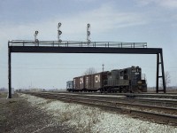 When I first dug out this image I realized I had forgotten those huge overhead signal structures along the old line at Welland. All that track, heck, it looks like a raceway.
In this early spring view CR 7438 with a couple of boxcars and ever present caboose is heading eastward. In the background the Welland TH&B/CR yard office is visible, the same one that is there today. And out front was TH&B 73I know, because I went down to get a picture of it after this train went by.