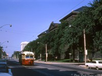 TTC PCC 4382 (an A6-class car built by CC&F in 1947-48) heads eastbound on College Street on a Carlton run bound for Danforth & Main, passing the University of Toronto's Mining Building (dating from 1905) at the corner of College and Taddle Creek Road. Judging by the lack of automobile and pedestrian traffic, this was likely taken on a Saturday or Sunday downtown. The white building in the background near Spadina is the Clarke Institute of Psychiatry, a modernist concrete office tower designed by John B. Parkin Associates and completed a few years earlier in 1964 (now the home of CAMH College St.). <br><br> Taddle Creek Road was named after a <a href=http://www.taddlecreekmag.com/the-forgotten-stream><b>small stream</b></a> that used to run through the area (that was buried and turned into an underground creek/sewer). The road formerly ran between College St. and Hoskins through the UofT campus, but was broken up into segments (it became parts of Tower Rd., Hart House Circle, King's College Cir.) around when the Medical Sciences Building was built in 1969. A small stub of Taddle Creek Rd. remained off College as a service road into the early 2000's, until the UofT's Donnelly Centre was built over it in 2005. <br><br> <i>Original photographer unknown, Dan Dell'Unto collection slide.</i>