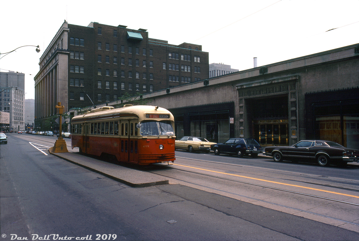 "Toto, I have a feeling we're not in Kansas anymore": TTC A14-class PCC 4779, operating on a farewell fantrip for the TTC's fleet of secondhand Kansas City streetcars, is pictured facing west on College Street at Bay Street beside iconic Eatons College Street store. The 65 Dodson route exposure isn't one of the TTC's, rather, it is from a Kansas City rollsign installed in 4779 specially for the occasion. The usual selection of 70's automotive iron pictured lined up outside Eatons wouldn't be complete without an AMC Gremlin and VW Bug thrown into the mix.  The 30 TTC A14-class PCC streetcars (4750-4779, built 1946-47) were purchased secondhand from Kansas City in 1957 and were the last group of secondhand PCC's acquired by the TTC, but due to their condition they were the first ones to be retired and sold off. Most were resold to MUNI (San Franciso) and SEPTA (Philadelphia) for continued use, with the last one (4779) retiring a few months after this photo was taken. The TTC would continue to operate much of its other secondhand and purchased-new PCC cars in regular service until the last ones were retired in the 90's.  Opened in 1930, the Eaton's College Street store was originally envisioned to be a much grander complex (including a headquarters office tower) until the Great Depression caused Eatons to scale it down. The seven-floor Art-Deco department store building housed 600,000 square feet of retail space dedicated to house furnishings, furniture, fabrics and wall hangings, electrical appliances, China and linens, and included fashion and apparel specialty shops, a beauty salon, a portrait studio, a fine art gallery room, and an Art Moderne-styled 7th floor featuring a special restaurant and auditorium (to give an idea of how scaled-down it was, the original plans called for 5 million square feet of retail space!). The TTC for a time ran special inter-store Eatons shuttle buses between their flagship Queen Street and College Street stores.   But at the time of this photo Eaton's was well on its way to completing the first phase of its massive Eaton Centre development, including a new flagship department store with one million square feet of retail space off Dundas that opened a few months later in February 1977 and replaced both their Queen and College locations. Happily, the College Street store was spared the wrecking ball when it was sold off and turned into commercial retail and office space. Much of the heritage elements of the building have been preserved, including the restored 7th floor restaurant and auditorium used as a special events venue.  J. Bryce Lee photo, Dan Dell'Unto collection.