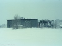 Two days after CN's London roundhouse at Rectory Street was gutted by an intense fire on Feb 12 1992, the city has received a snowfall - pictures from the day of the fire show a snowless scene. <br>
The CN logo seems a bit out-of-place on this steam-era roundhouse, which CN had ceased using about 3 years before the fire. Built in the early 1900's as a much larger structure, it had been reduced to six stalls. <br>  The London Free Press newspaper story about the blaze indicates that after vacating the roundhouse, CN had ongoing problems with break-ins by "vagrants". <br>  Location mapped is approximate. 