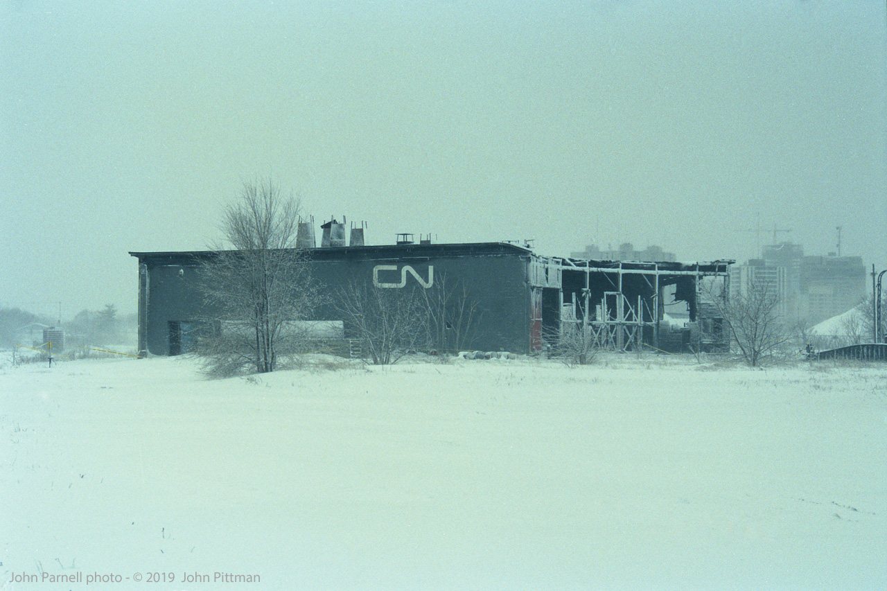 Two days after CN's London roundhouse at Rectory Street was gutted by an intense fire on Feb 12 1992, the city has received a snowfall - pictures from the day of the fire show a snowless scene. 
The CN logo seems a bit out-of-place on this steam-era roundhouse, which CN had ceased using about 3 years before the fire. Built in the early 1900's as a much larger structure, it had been reduced to six stalls.   The London Free Press newspaper story about the blaze indicates that after vacating the roundhouse, CN had ongoing problems with break-ins by "vagrants".   Location mapped is approximate.