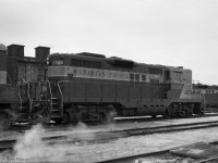 A pair of 1957-built GP9's CP 8707 and 8705 are at rest, apparently outside the roundhouse at CP's Lambton Yard (SW corner of Runnymede & St Clair) on 14 January 1962.  The back of 1959-built SW1200RS  CP8145 is also in the picture.  <br><br>
Complaints about coal smoke emanating from the Lambton roundhouse lead to the installation of large numbers on the smoke jacks. Presumably the smoke problem ended with the retirement of the last of CP's steam engines.  