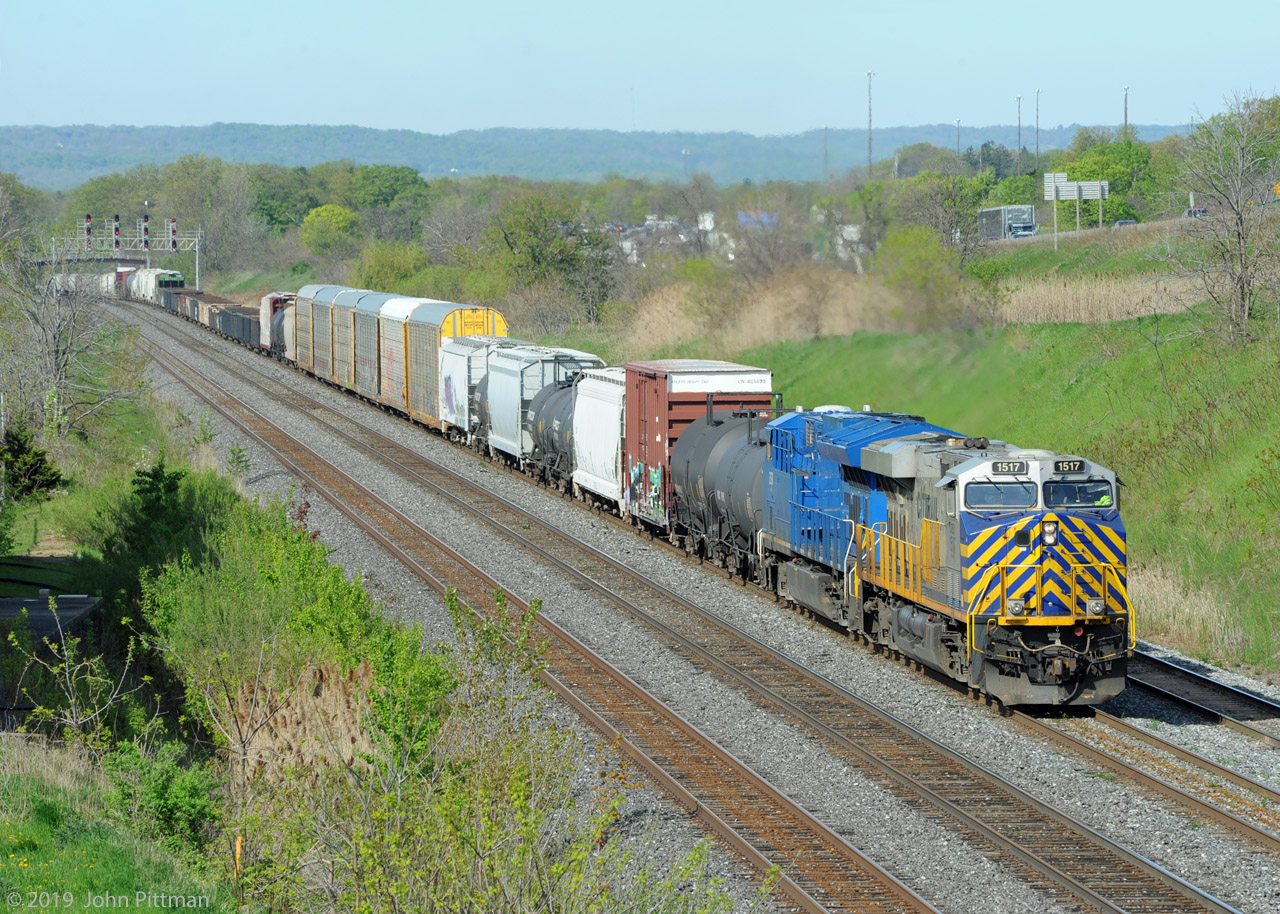 CN train 394 is eastbound on the Oakville sub powered by 2 leased units, Citirail ES44ac CREX 1517 and GE ET44ac GECX 2038. As I recall the detector reported 640 axles = 2 six axle engines and 157 railcars. 
Someone told me the first 2 digits of the CREX units is the last 2 digits of the year it was acquired.