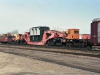 Schnabel car HEPX 200 has been in service for many years, moving heavy and oversize loads for Ontario Hydro and its successors. <br><br>
In this picture from 1992 it is lettered for Ontario Hydro with (looks-like) faded red paint, different from the orange Hydro One colour scheme it wears now. Another difference from recent pictures on RP.ca is that this load labelled "Lambton T.G.S." is carried on a cradle joining the car ends, rather than having the load slung between  the two ends of the Schnabel car.<br>
From adjacent images, it appears that this train is eastbound at London Jct, branching off the Dundas Sub onto the Guelph sub. Other frames from the film with same date show GP9rm units CN 7029 (leading long hood forward) and CN 7039 - I believe they powered this train. The caboose is CN 78122. 
