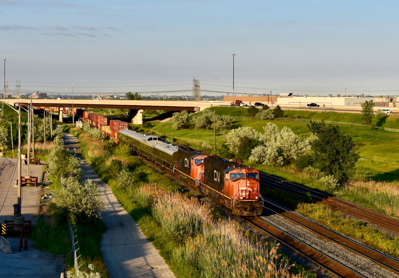 Under the fine looking evening sun on one of the longest night of the year, we find CN Intermodal 149 on the roll westbound with some goodies! Train has just departing the CN BIT moments ago and before the regular intermodel cars, we find a stack of 5 CN Buisness coaches! While I am not sure where they were destined for nor their purpose, it was a treat in general to be able see them and add them to my collection! The power was nice too, CN sd75Is 5701 and 5774! Both facing forward! Time is 19:49 and photo was taken directly on top of Bramalea road which is just east of the station! Highway 407 is the overpass half a mile or so away!
