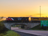 The sun has began to rise for another day, as westbound train Q121 gets up to speed at Berry Mills, shortly after departing Moncton, New Brunswick. EMDX 1606 is trailing in the consist. 