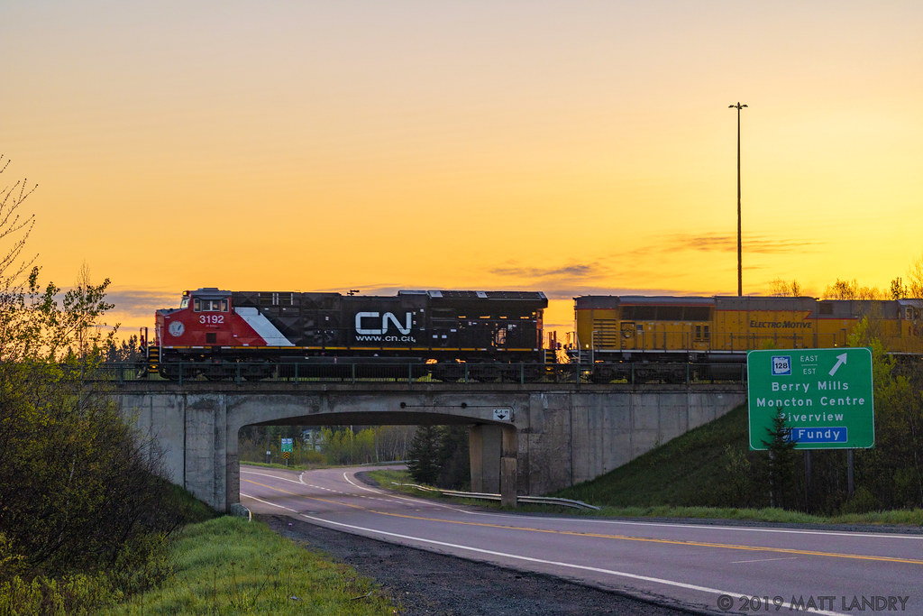 The sun has began to rise for another day, as westbound train Q121 gets up to speed at Berry Mills, shortly after departing Moncton, New Brunswick. EMDX 1606 is trailing in the consist.