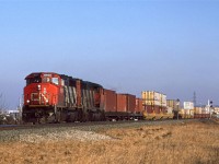 I suppose that there is nothing special about a double stack container train these days, but in 1995, CN was just ramping up this type of service (much later than in the US). There is also the fact that it is being pulled by 4-axle locomotives....
In spite of having my radio on, I did not get the train designation. Perhaps they did not speak with Edmonton's Switchtender. 