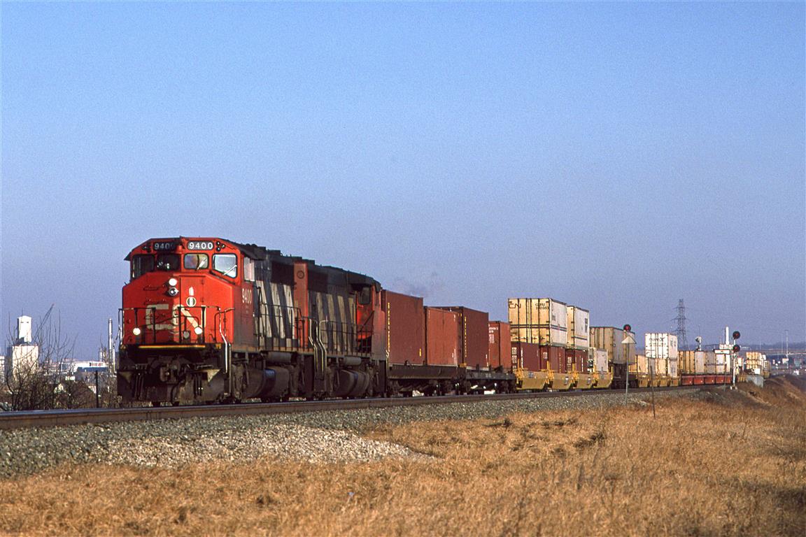 I suppose that there is nothing special about a double stack container train these days, but in 1995, CN was just ramping up this type of service (much later than in the US). There is also the fact that it is being pulled by 4-axle locomotives....
In spite of having my radio on, I did not get the train designation. Perhaps they did not speak with Edmonton's Switchtender.