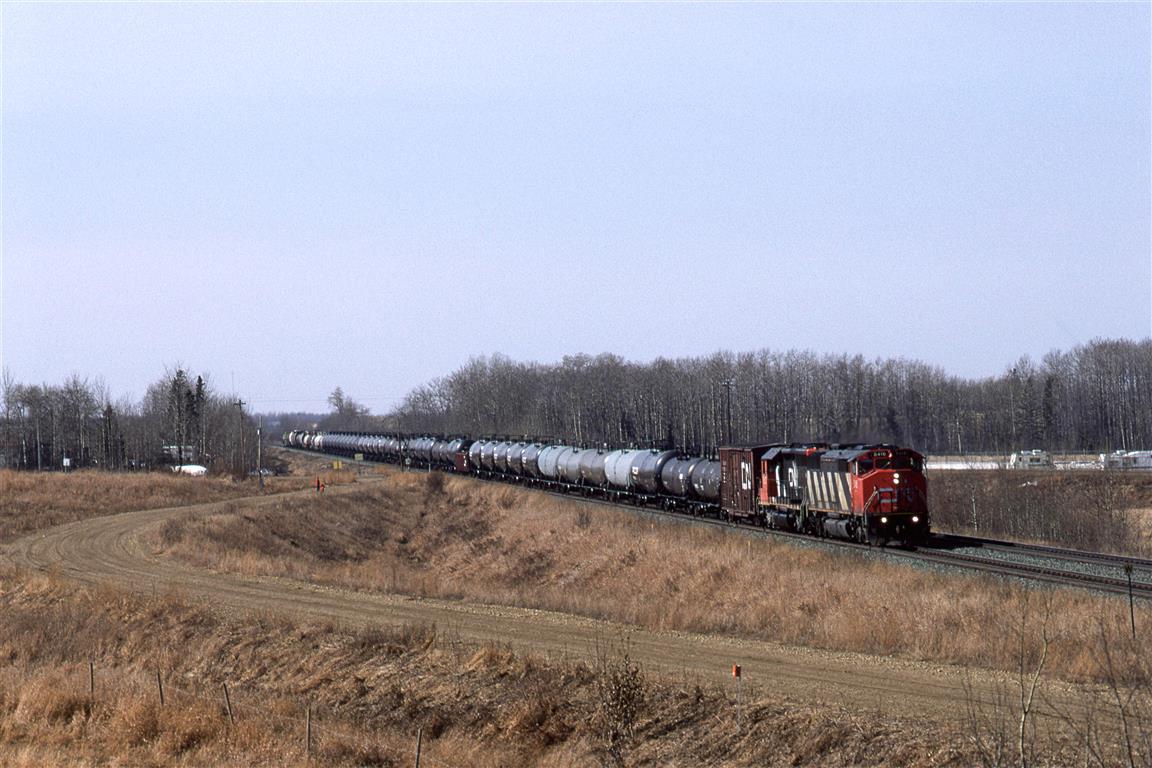 After the 1995 strike.....and the first train to arrive in Edmonton from the west was this chemical train. 
My wife and lids are on the grade for a shoefly as a bridge is to be built for highway 216 at this location.