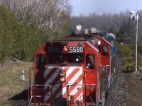 Shortly after our daughter was born, we flew east to visit our families in Ottawa and Halifax. I heard this train come through at about the same time for a couple of days and decided to try to catch it on the third day. True to form, it showed up in a timely fashion. 
Although the train is numbered 905, it is headed eastbound. Something seems strange.
The location is approximate. Tracks are no longer in place and the area has developed rather significantly.