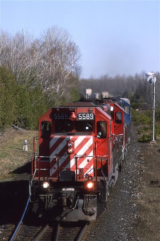 Shortly after our daughter was born, we flew east to visit our families in Ottawa and Halifax. I heard this train come through at about the same time for a couple of days and decided to try to catch it on the third day. True to form, it showed up in a timely fashion. 
Although the train is numbered 905, it is headed eastbound. Something seems strange.
The location is approximate. Tracks are no longer in place and the area has developed rather significantly.