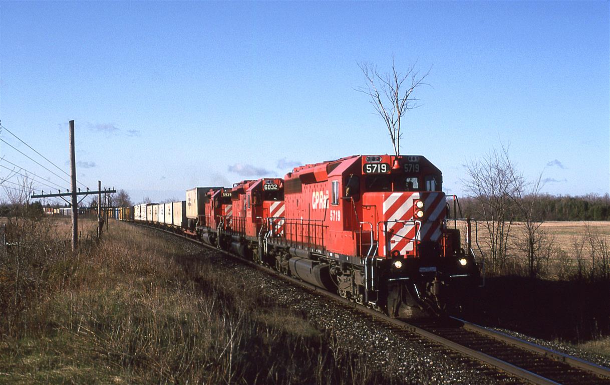 I was expecting a train from the north (eastbound)  as I had seen the day before and heard the two days before that, but this one came in from Smiths Falls, This is now a trail and the Carlton Place airport occupied the field behind the locomotives.