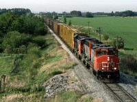 With an extra car in the driveway (we purchased a 4 door car with the arrival of our second child, and were in the process of selling our older car), I had access to wheels. Unfortunately, I could not get a drivers license on account of my vision. This is where Fred Clark came in. He, too came from a one vehicle family, and his wife needed to to get to her office. With the academic term at U of A closing, Fred had time for some fun. We took the car out to see what we could find. #579, running up the Cornodado Sub seemed like a good candidate to chase.
Here it is, just past St Paul Junction, now fully on the Coronado Sub, about to duck under Highway 15.
Back then, at 0800 hrs, the dispatchers would transmit a lineup for each subdivision.