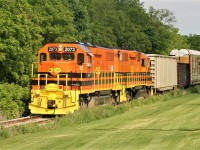 Goderich-Exeter Railway (GEXR) train 580 with GEXR GP38-3 2073 and GEXR GP39-2u 2303 is seen approaching Queen Street in Kitchener on the Huron Park Spur on June 6, 2018. The train is returning to the Kitchener yard with several cars lifted from the interchange with Canadian Pacific.