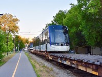 With Waterloo Regions LRT system said to be opening in less than a day now, I thought it would be a good time to share one of my favorite shots from last summer and it was of GEXR’s Kitchener-Elmira switcher (584) taking 2 of the brand new LRV Light Rail Vehicles up the Waterloo Spur with them on flatbeds (behind their usual short stash of tank cars) for delivery to the region! 
In this scene here the sun has just gone down and GEXR 584 has just began it’s 11 mile trip up the Waterloo Spur with the 2 of the brand new Light Rail Vehicles behind its 6 loaded tank cars. Right near the halfway point between Kitchener and Elmira, GEXR will set off the 2 new LRVs in the very rarely used spur to Commonwealth Plywood which is just about a mile north from the new ION Maintenance facility and from there the region will pick them up, unload them and get them ready for testing!! Time was 20:45 and photo was taken just north of the Wellington st crossing in Downtown Kitchener. GEXR power (out of sight) was 2303 and 2073.