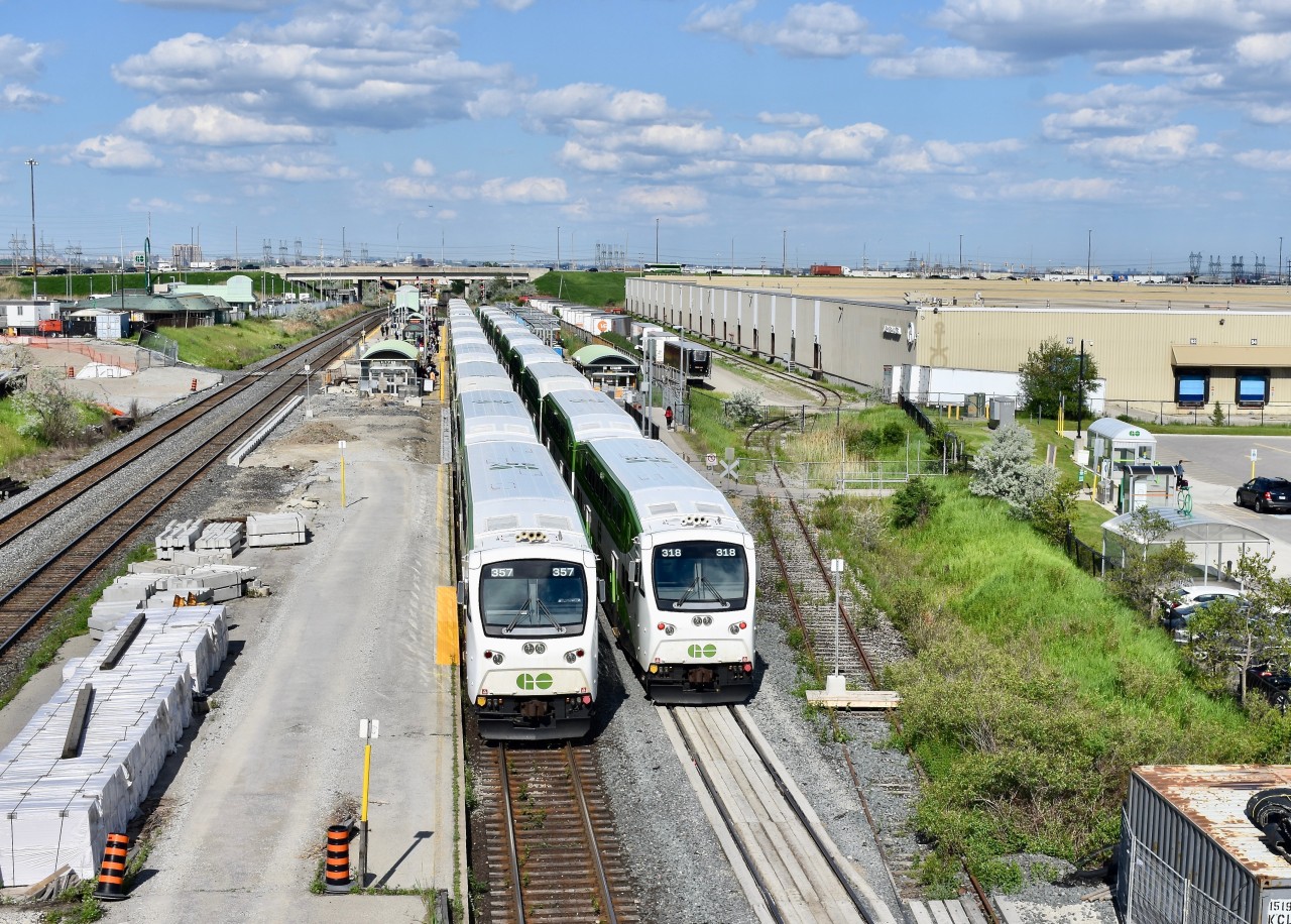Construction of platform expansion/upgrades at Bramalea GO continues to make progress in 2019! Here we find 2 of the rush hour GO trains parked side by side on tracks 3&4 at Bramalea to let off passengers who are commuting home from Toronto. The train on track 4 (which has cab car 318 in the lead) happens to be a older 10 car train which only ran as far as Bramalea meanwhile, 357’s train on track 3 happens to be one of the a newer 12 car trains and it will continue on westbound throughout afternoon rush hour until eventually reaching its finishing point at Kitchener GO.   On both trains (depending on where they were sitting), passengers getting off at Bramalea had to move up several coaches before getting off as certain sections of both platforms are closed off for the ongoing construction of platform expansion. By the time the project is all complete, Bramalea GO would hopefully be able to accommodate all 12 car trains so passengers won’t have to get up and walk down several coaches before hopping off.   With the newer block of wood and warning sign (to warn construction workers I assume) resting right on top of the disused spur into Kuehne + Nafel just after the switch, it appears that yet again they aren’t really interested in any kind of rail service. Looking at the length of their building, it appears that their spur accommodated well over a dozen box cars back in the day but now (like most buisness in Brampton), they’ll likely choose to rely on CN BIT with any rail shipments. Time was 17:19