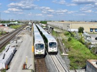 Construction of platform expansion/upgrades at Bramalea GO continues to make progress in 2019! Here we find 2 of the rush hour GO trains parked side by side on tracks 3&4 at Bramalea to let off passengers who are commuting home from Toronto. The train on track 4 (which has cab car 318 in the lead) happens to be a older 10 car train which only ran as far as Bramalea meanwhile, 357’s train on track 3 happens to be one of the a newer 12 car trains and it will continue on westbound throughout afternoon rush hour until eventually reaching its finishing point at Kitchener GO. <br>  On both trains (depending on where they were sitting), passengers getting off at Bramalea had to move up several coaches before getting off as certain sections of both platforms are closed off for the ongoing construction of platform expansion. By the time the project is all complete, Bramalea GO would hopefully be able to accommodate all 12 car trains so passengers won’t have to get up and walk down several coaches before hopping off. <br> <br> With the newer block of wood and warning sign (to warn construction workers I assume) resting right on top of the disused spur into Kuehne + Nafel just after the switch, it appears that yet again they aren’t really interested in any kind of rail service. Looking at the length of their building, it appears that their spur accommodated well over a dozen box cars back in the day but now (like most buisness in Brampton), they’ll likely choose to rely on CN BIT with any rail shipments. Time was 17:19