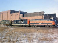 CN-leased Bessemer & Lake Erie F7A 720A sits coupled to CN GP9's 4594 (in the new CN noodle scheme), 4600, and an RS18, sitting by the huge Ice House (for icing refrigerator cars) northeast of the Mimico Yard roundhouse.<br><br>Today, the site of CN's old ice house is home to VIA's Toronto Maintenance Centre building. CN eventually rebuilt their old high-nose GP9 fleet as chop-nose units for roadswitcher and yard work. B&LE 720A also still exists, currently owned by the Grafton & Upton RR as their 1501.