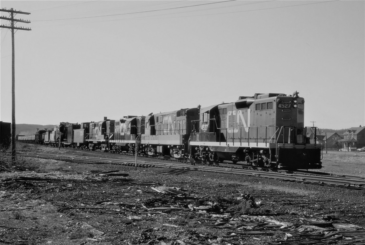 Its April in Northern Ontario and the only trace of spring is CN sending out work equipment to begin the summer maintenance program. Pulling out of Capreol on the now abandoned Alderdale Sub, train 524, operating as time table train 954, has a nice mix of power in the form of GP9 4527, H16-44 2203, GP9 4484, and RS-18 3719 and an even nicer consist which includes a steam powered pile driver. The pile driver will be set out at Field, Ontario to work on a bridge. The ore cars are heading to the mine at Skead.