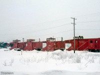 Palmerston was the base for many of CN's branchlines in the "Snow Belt" area east of Lake Huron. Here we see a GP9 and four CN snowplows (with plow 55614 closest) stationed at the yard ready for service in February 1976.