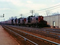 CN didn't buy any RS1s but it did have a similar MLW-designed units, the 1000 hp A1A-truck RSC13. These units replaced steam on many branch lines in Ontario and Quebec (and initially on Vancouver Island!). Around 1965, 13 of these engines had the centre axle removed and were assigned to tranfer duty in the Toronto and Montreal areas. (The middle axle was later re-installed and the units assigned to the Maritimes until their retirement in the mid-1970s.) Here we see three  "tractors" leading an eastbound train onto the Halton sub at Burlington.(If RSC13s were "tractors" and SW1200RS' were "pups"...I wonder what the nickname was for GMD1s?)