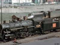 CN 0-8-0 switcher 8438 (a P4b-class unit built by the Grand Trunk in 1923) is seen switching cars at Bathust Street in busy downtown Toronto in 1958. In the late 1950's, diesels were slowly taking over the last of the steam assignments, as evident by MLW S3 8456 switching a passenger express reefer nearby. 8438 too would soon be replaced, and eventually scrapped in August 1961.