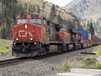 CNXE 2647 with the 2222 and 2244 at Drynoch on the CPR Thompson Sub at Shaw Springs, BC. The area was used in the 1880's by CPR as a work camp while building the railroad. The Shaw Springs Resort was homesteaded by William Shaw and his wife in the late twenties and in 1953 the Shaws requested the name Drynoch be changed to that of the resort but the request was rejected by the CPR and the Geographical Names Board. The Trans Canada Hwy runs parallel with this location and the Shaw Springs Restaurant and camp ground, closed for many years now, sits just across the highway from the Drynoch SNS.   