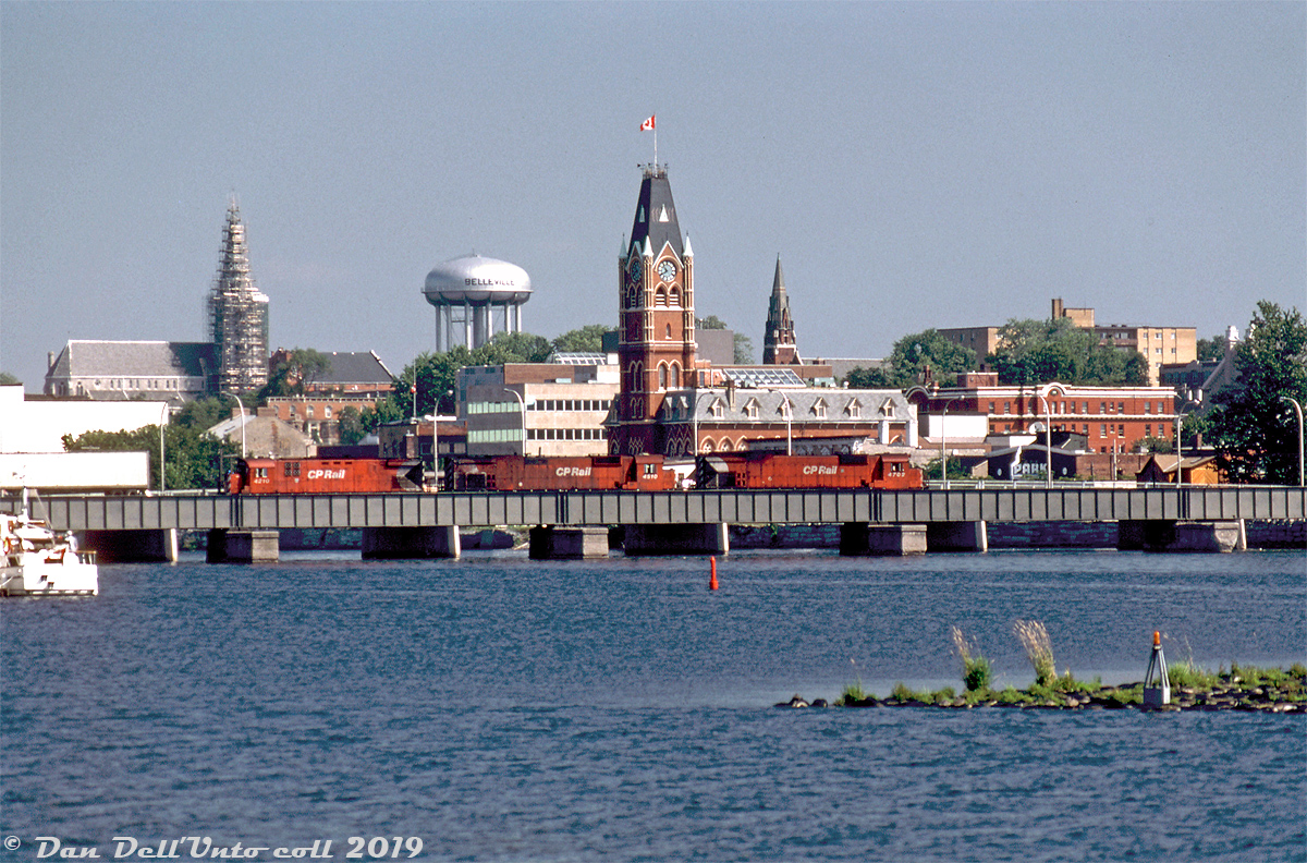 The clock on Belleville City Hall shows 10:40 in the late morning, as CP M636 4702, M630 4510 and C424 4210 lead an eastbound CP freight through downtown Belleville on the Belleville Sub over the bridge over Belleville Harbour. The Belleville water tower is also visible here.

Keith Hansen photo, Dan Dell'Unto collection