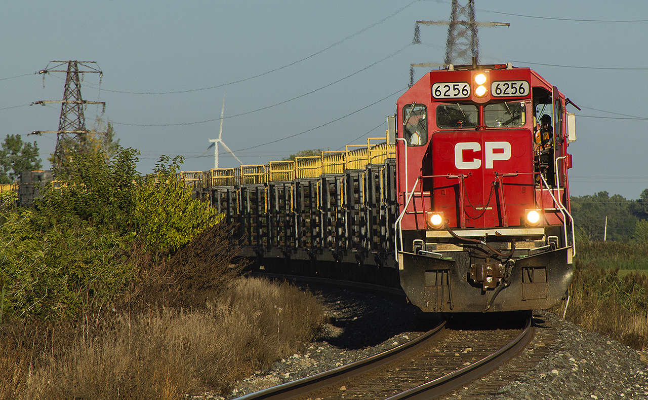 The late summer of 2018 roved to be a hot and humid one. Driving east from Tilbury, I saw this train at a distance heading west. Thinking I would be cutting it close, I quickly turned the car around and sped over to Rogers Road. This spot has always had a good vantage point with trains quickly coming around the bend. However, since this was before CP's recent work of clearing the shrubs away, and with the fading sunlight my only shot was to use my 75-300mm lens to attempt a head on shot. 


And then I waited...and waited...and waited. Finally after a half an hour I heard the horn blow for the Monpetit Road crossing. And the train finally appeared...slowly rounding the curve. On point is CP 6256, a former SOO. And as I clicked away, the second engine passed in 6258, also formerly a SOO. Once it passed at a snail's pace, it stopped and started backing up. Then it continued slowly into the siding at Tilbury. 


Even though it is the rail train, it was still worth the wait to see two former SOO units.