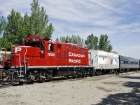 Aspen Crossings passenger train headed by GP9u CP 1624 sits in the station waiting to make it's Sunday run.